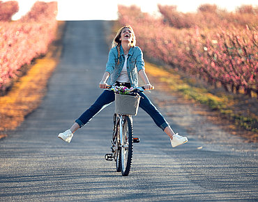 Frau freut sich auf ihrem Fahrrad